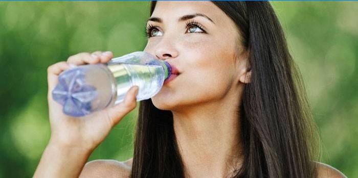 Mädchen trinkt Wasser aus einer Flasche